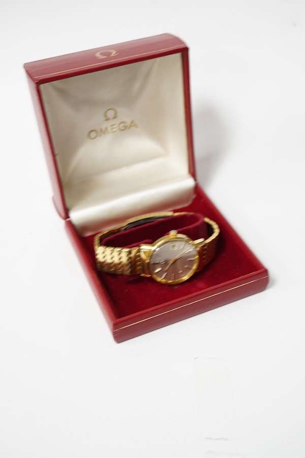 A gentleman's steel and gold plated Omega automatic wrist watch, with baton numerals and date aperture, on a steel and gold plated Omega bracelet, case diameter 35mm, box, no papers. Condition - fair